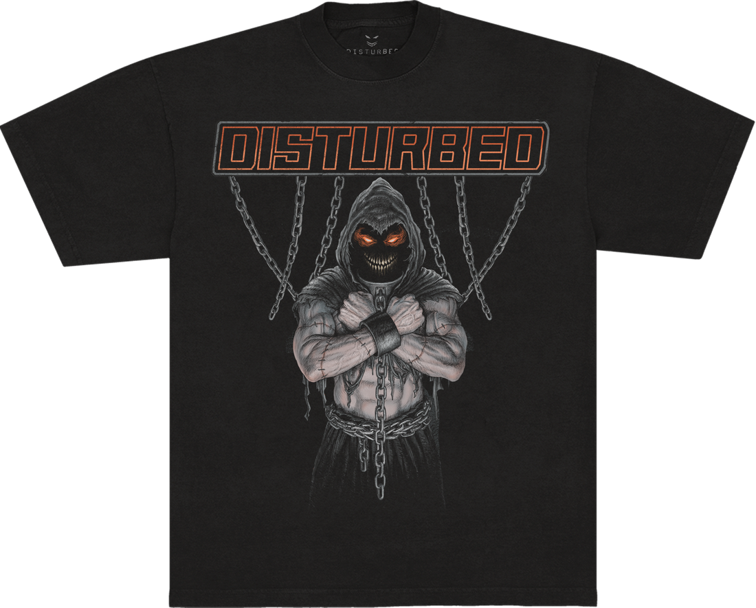 A black short-sleeve t-shirt featuring a graphic of a hooded skeletal character with glowing orange eyes and chains, under the word &